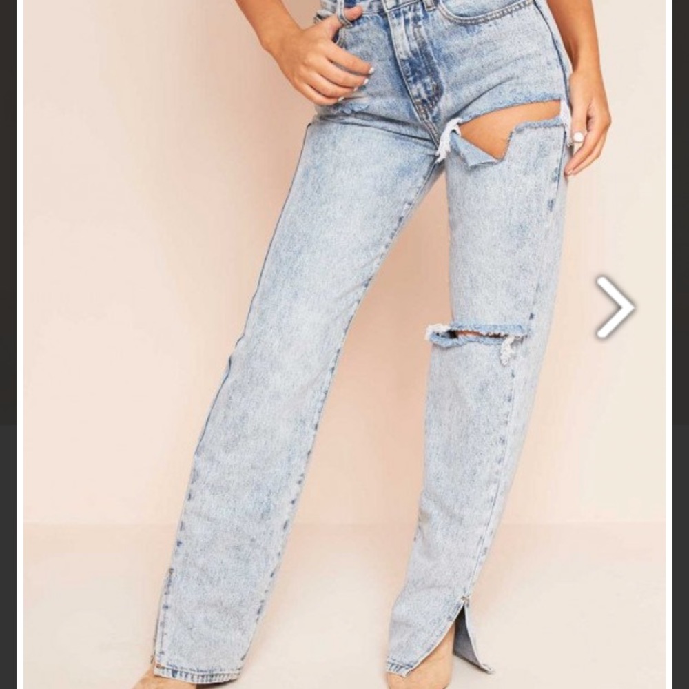 Split light blue jeans